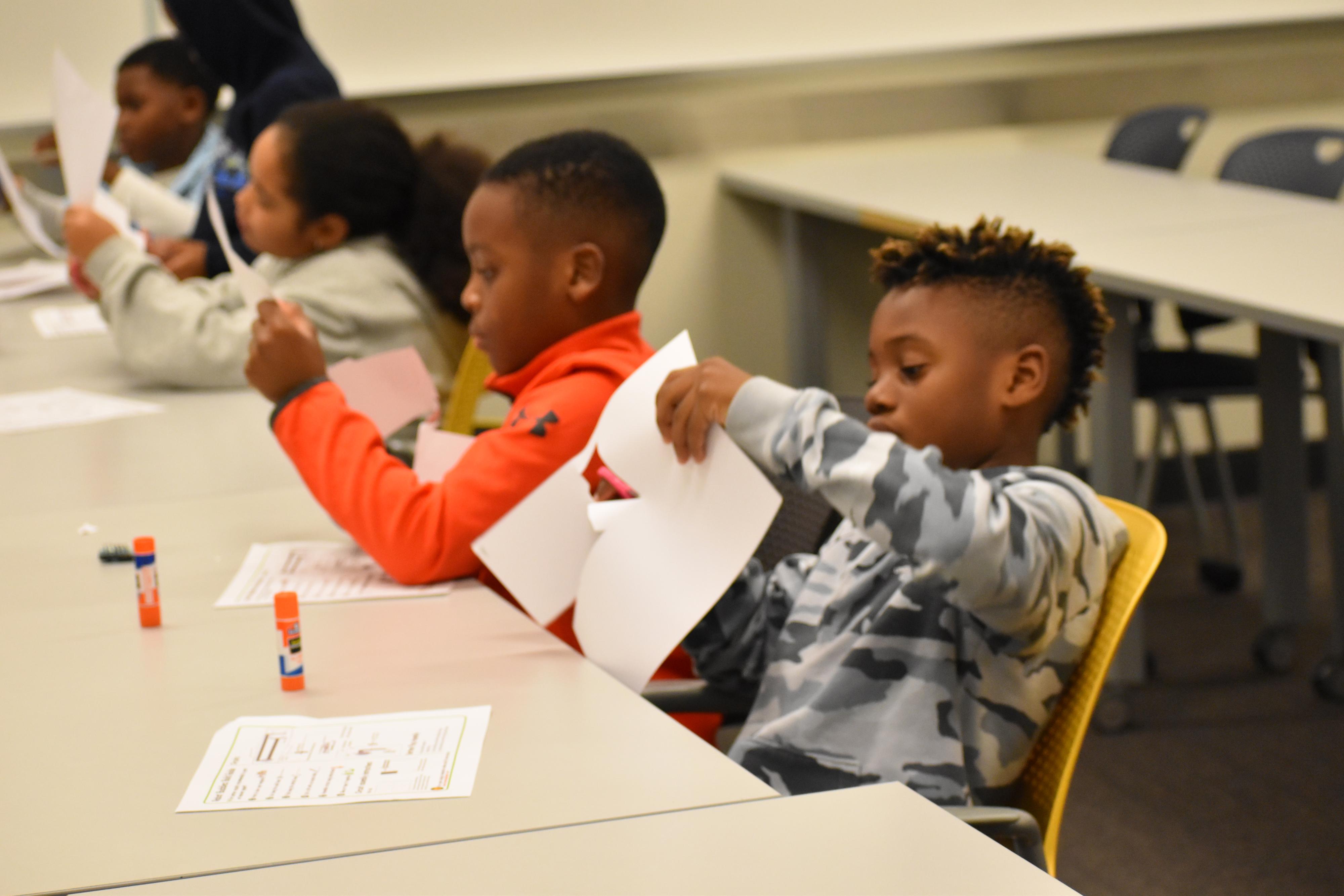 Children doing an activity with paper.